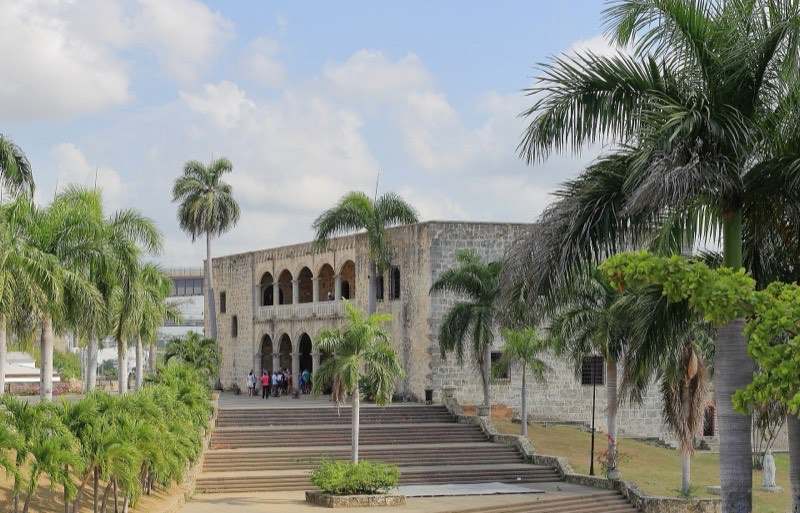 The Alcázar de Colón palace framed by royal palms, Santo Domingo