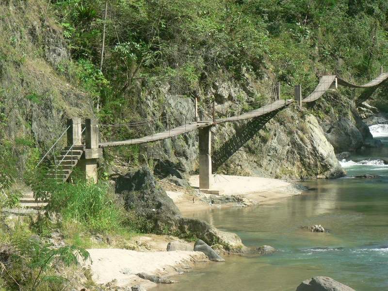 Wooden suspension footbridge crossing the river gorge near Jarabacoa