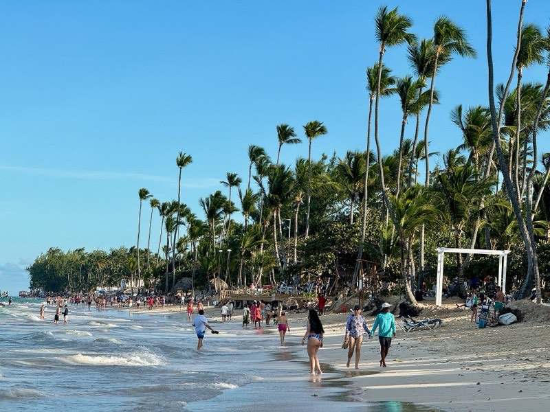 Beachgoers and tall palms along Playa Bávaro, Punta Cana